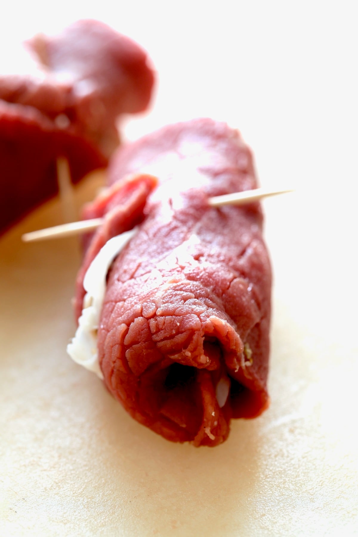 Close-up photo of one piece of Beef Braciole showing how sides are tucked in.