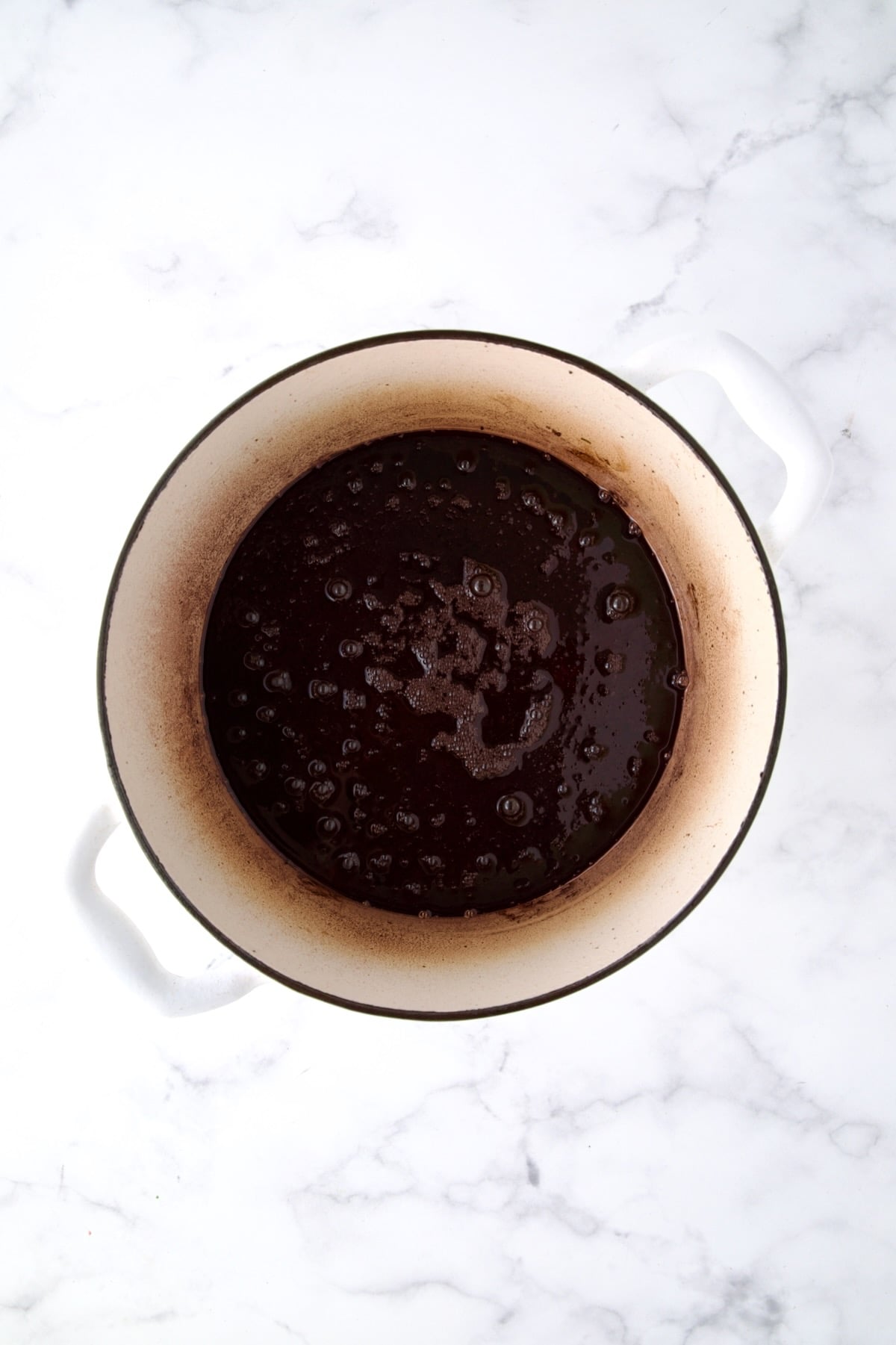 Red wine added to white Dutch oven after beef rolls are browned.