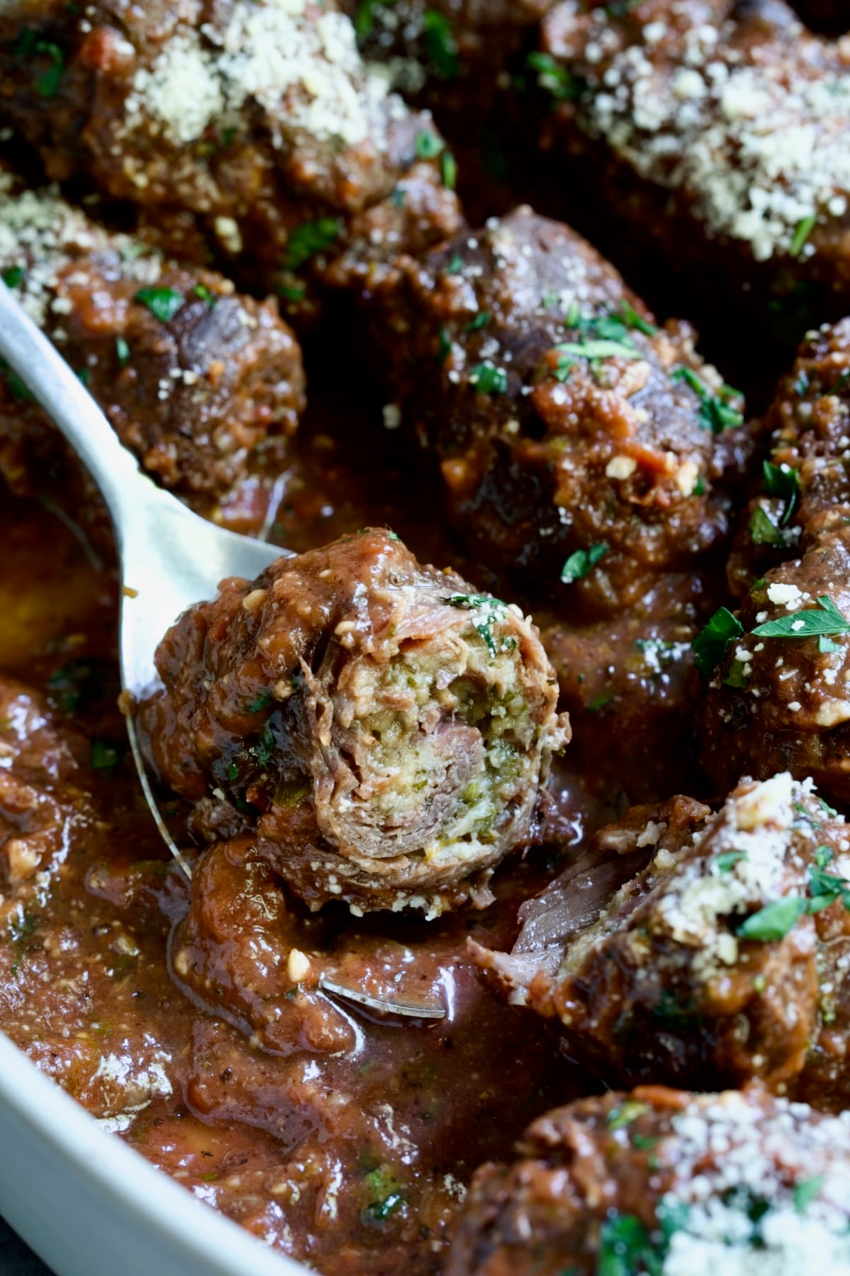 Beef Braciole cut in half to expose filling.