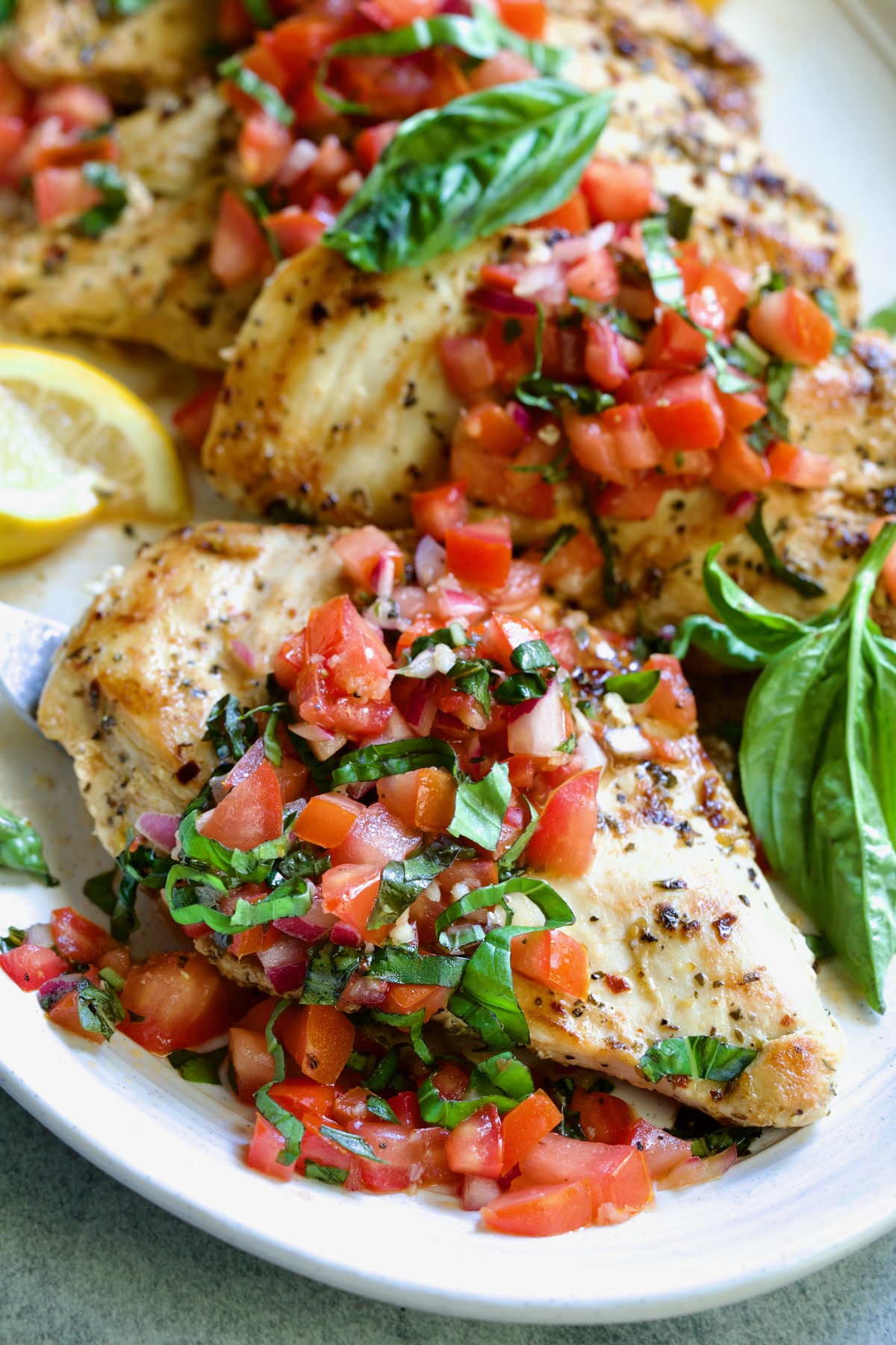 Chicken Bruschetta on oval white platter.