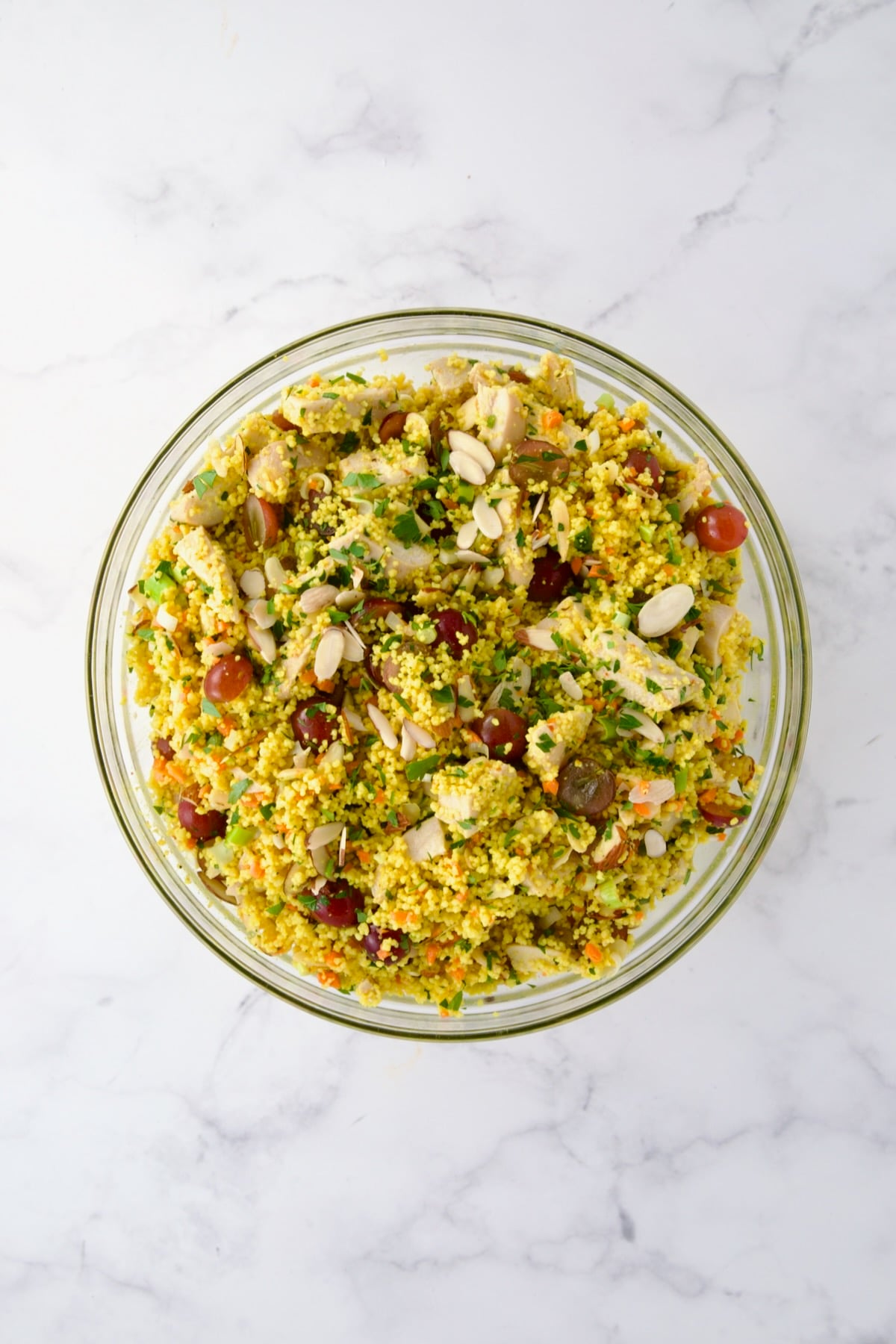 Ingredients for Chicken Couscous Salad in glass bowl after being combined.