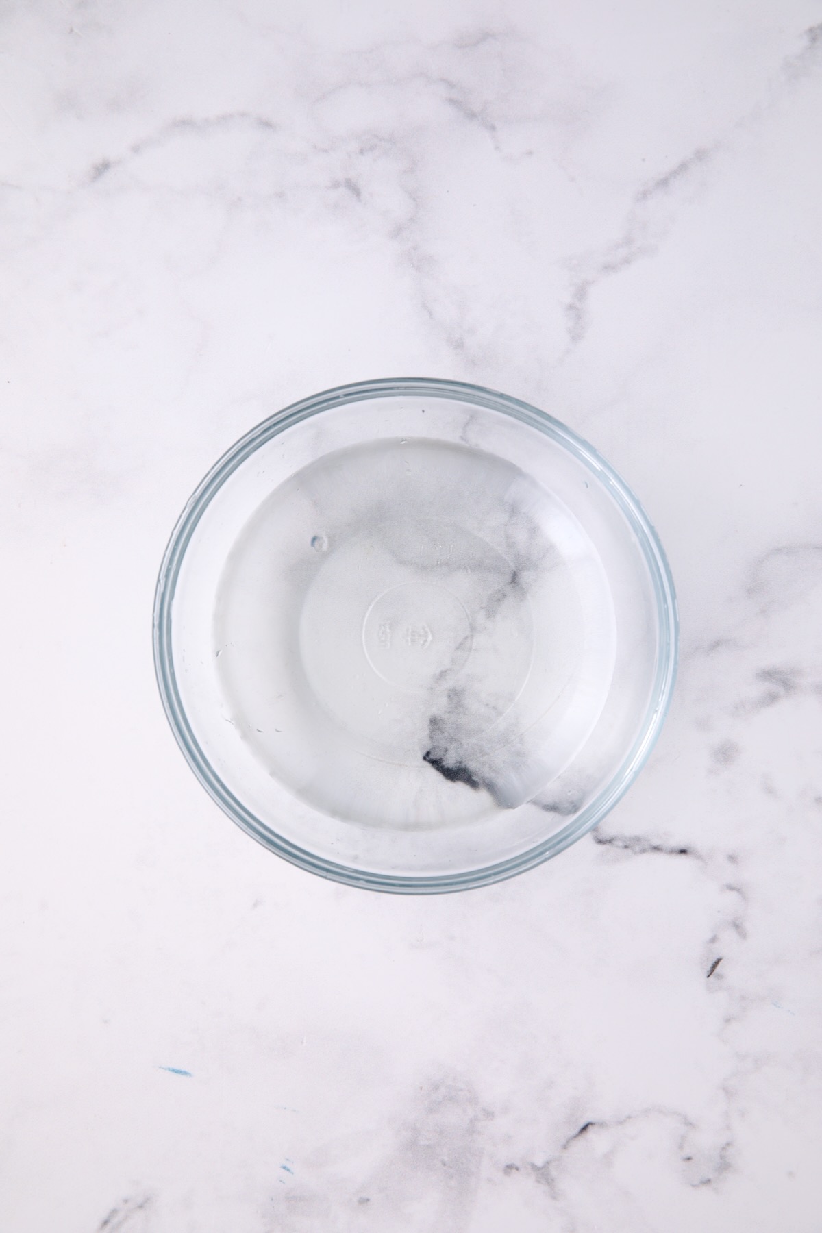 Vinegar, water and sugar dressing for salad in glass bowl.