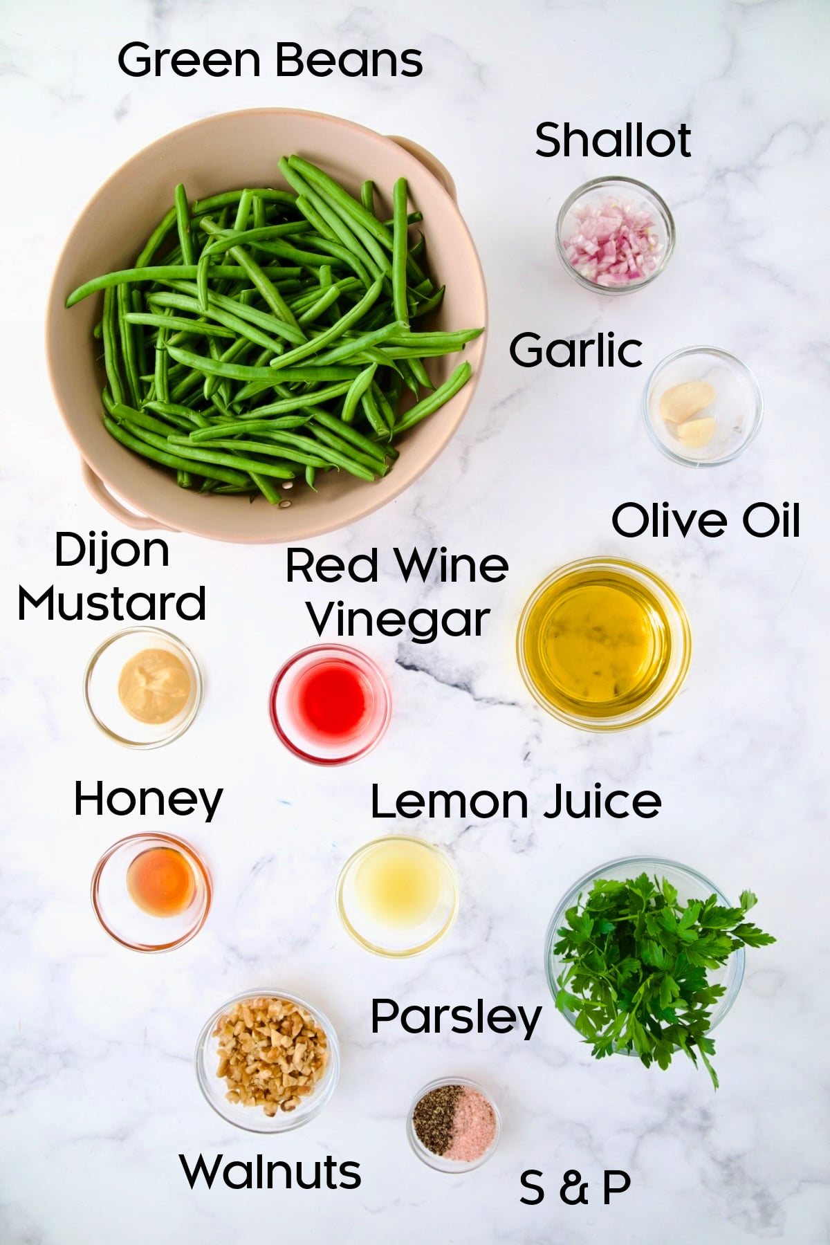 Ingredients for Green Bean Salad with Mustard Vinaigrette in glass bowls.