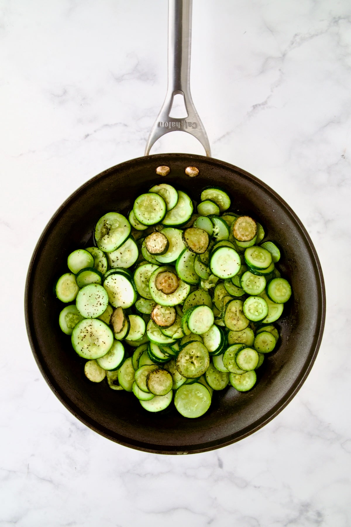 Cooked zucchini rounds in nonstick skillet.
