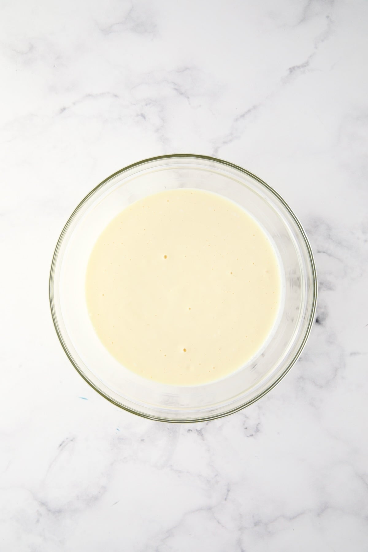 Egg, mayonnaise, cream cheese and milk mixture in glass bowl.