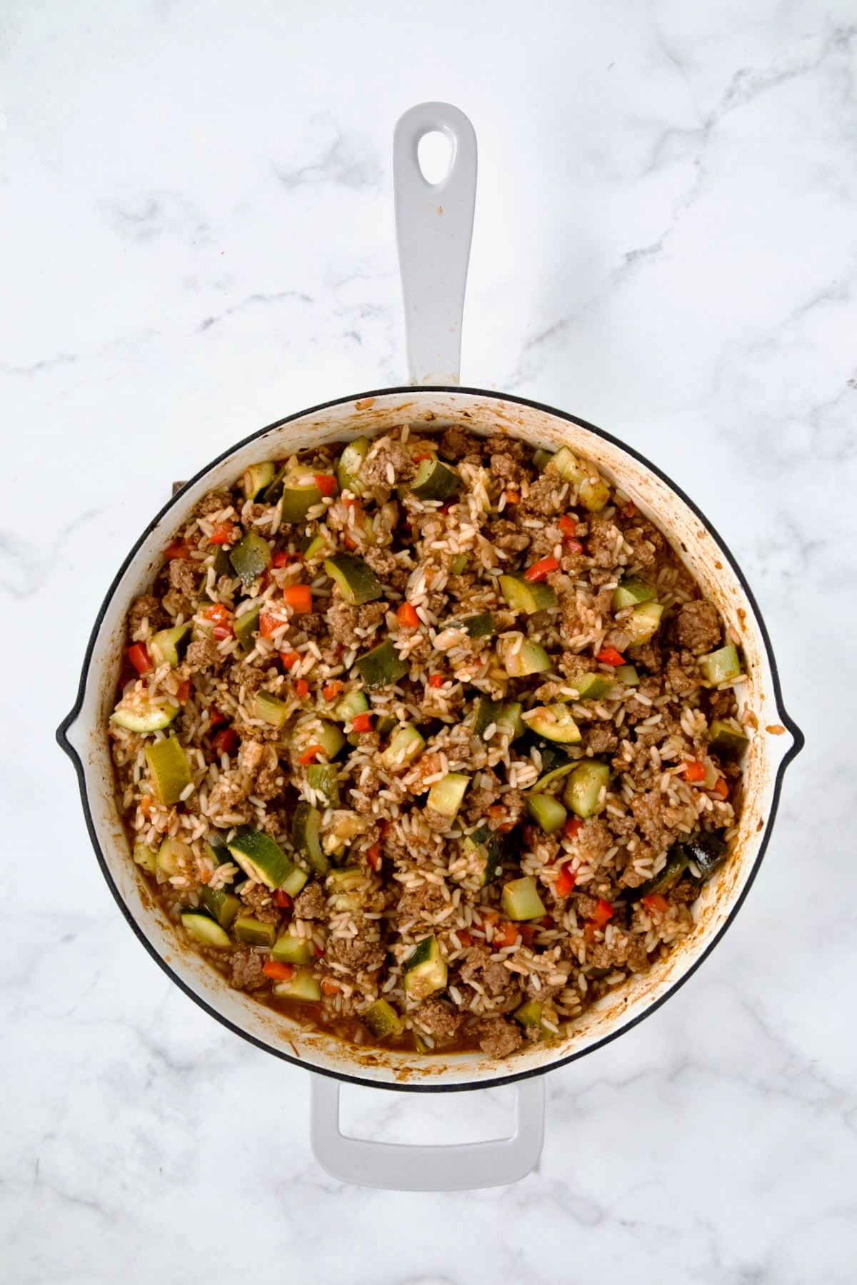 Everything cooked in white enamel cast iron skillet before cheese is added.