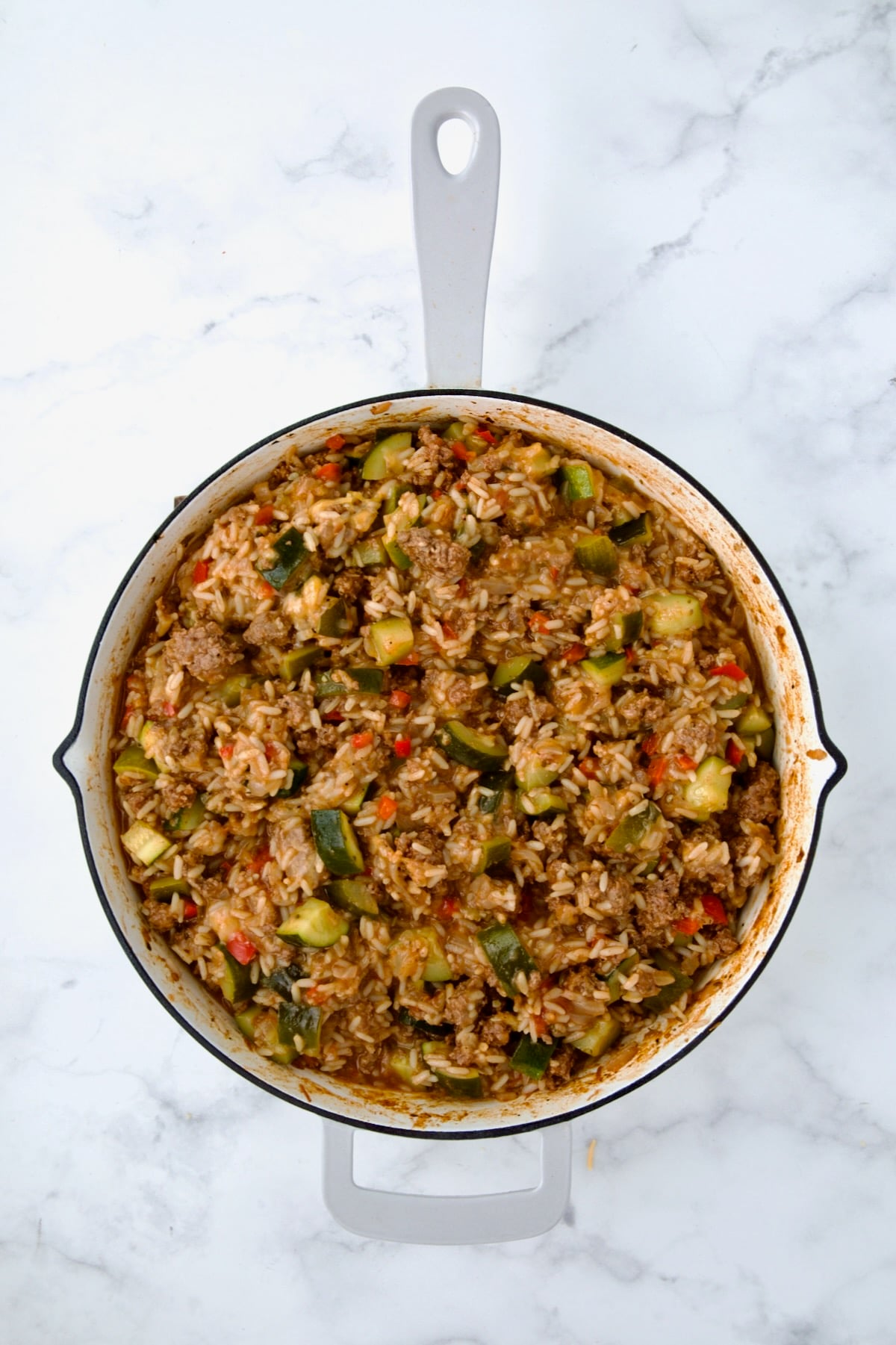 Finished Beef Zucchini Rice Skillet in white enamel cast iron skillet.