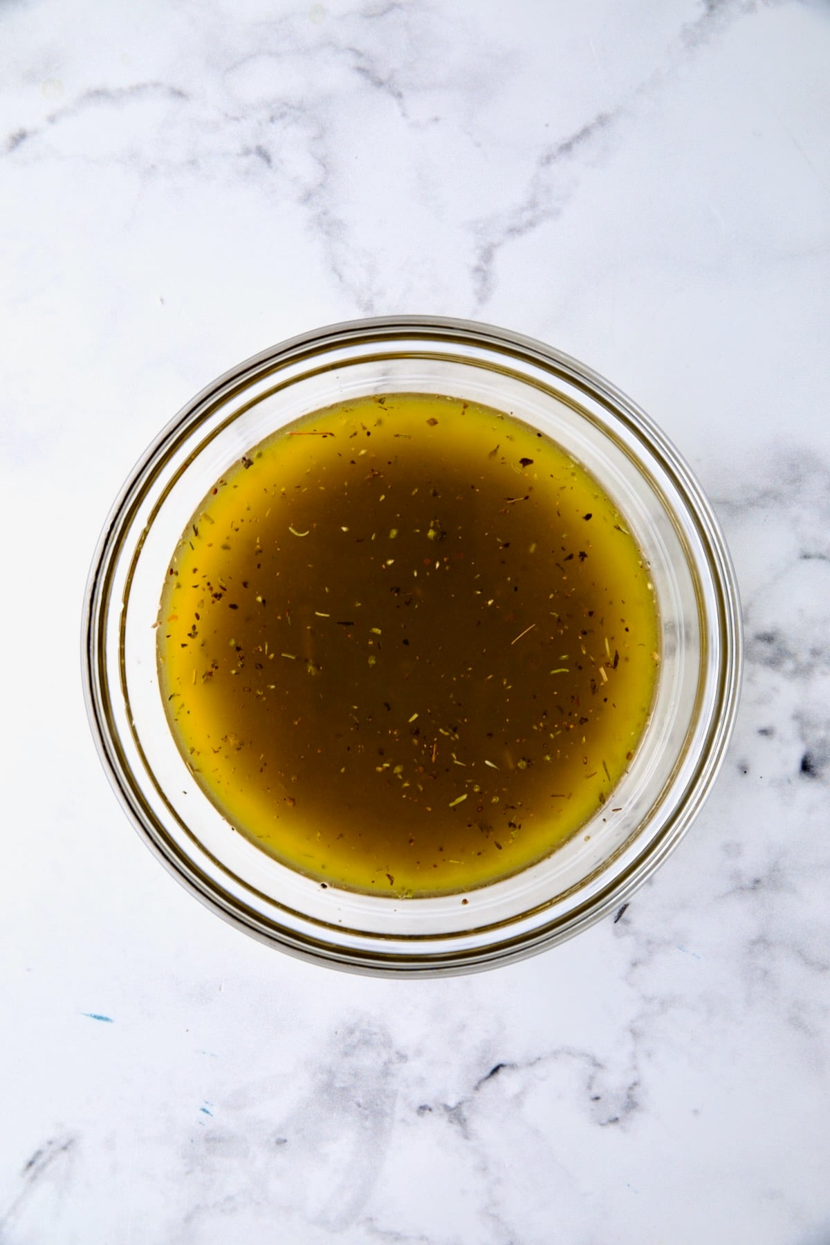 Salad dressing in glass bowl.