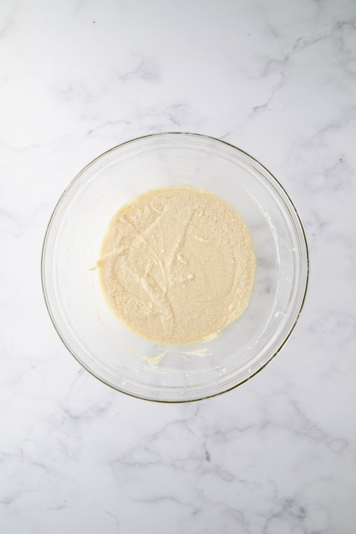 Wet ingredients for muffins in glass bowl.