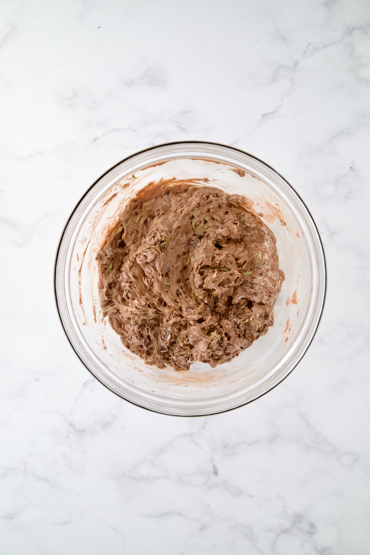 Batter for chocolate muffins in glass bowl.