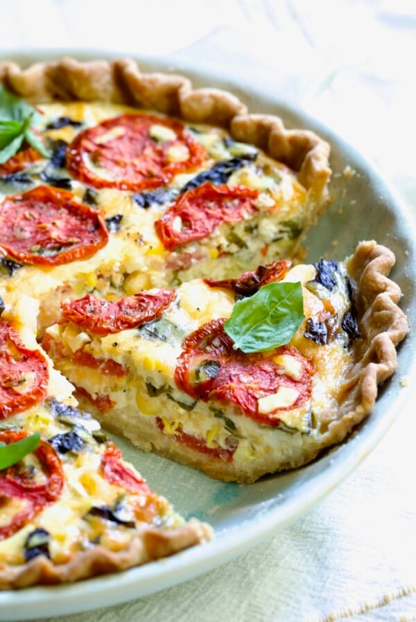 Tomato Pie Recipe with Corn and Basil with the focus on one piece.