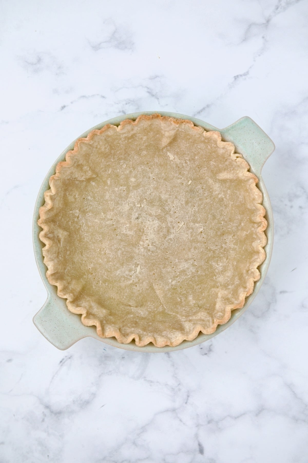Blind baked pie crust in pie pan.
