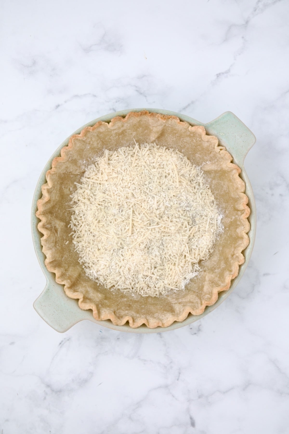 Parmesan cheese and all-purpose flour placed over the bottom of the baked pie crust.