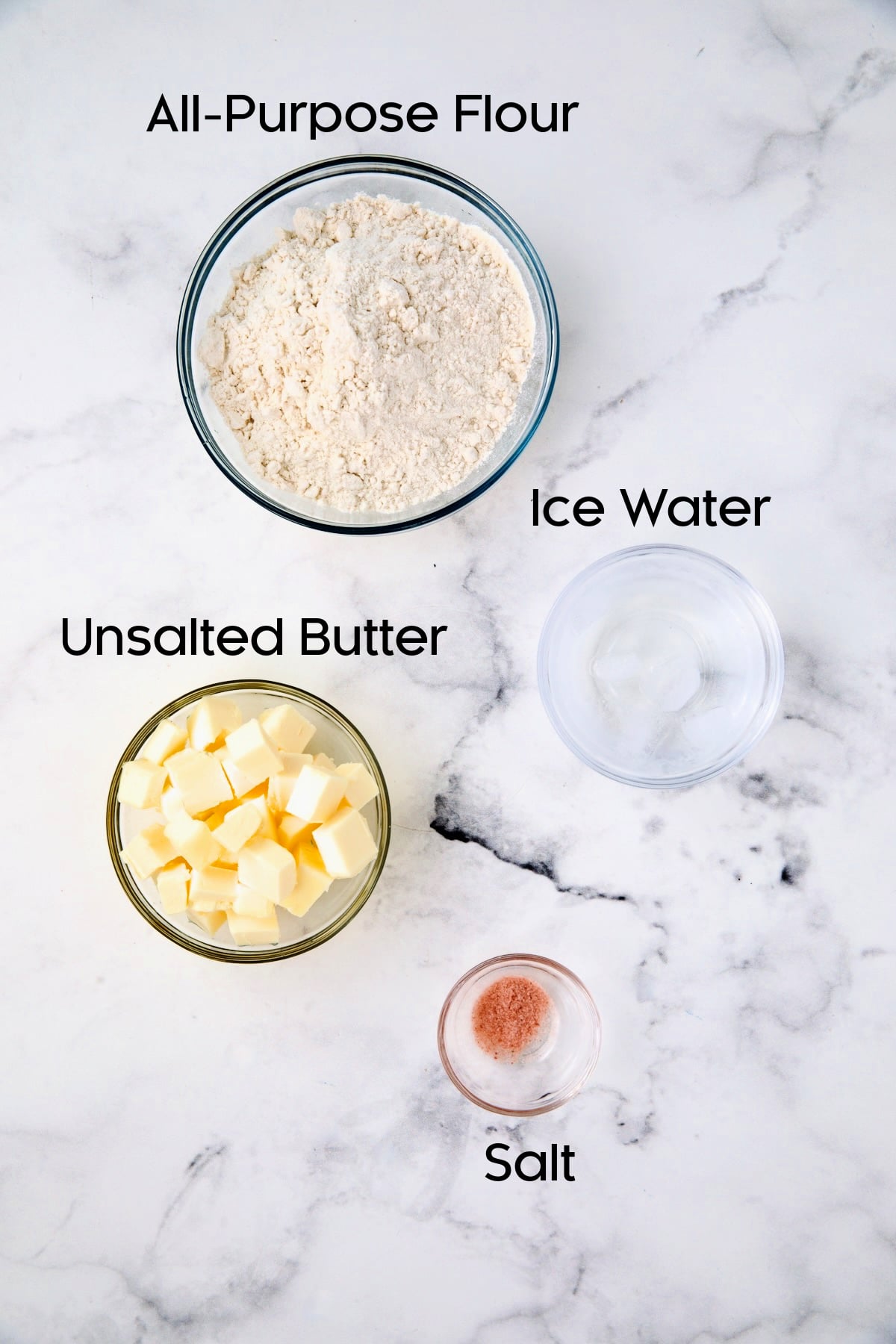 Ingredients for pie crust in glass bowls.