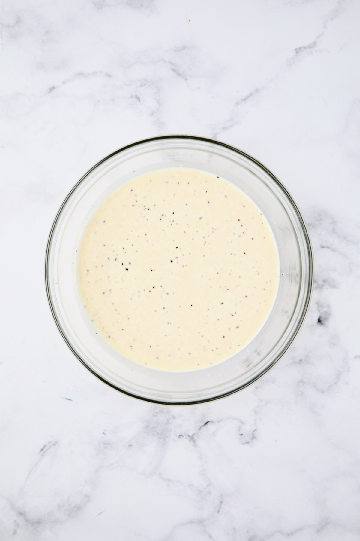 Custard for tomato pie in glass bowl.