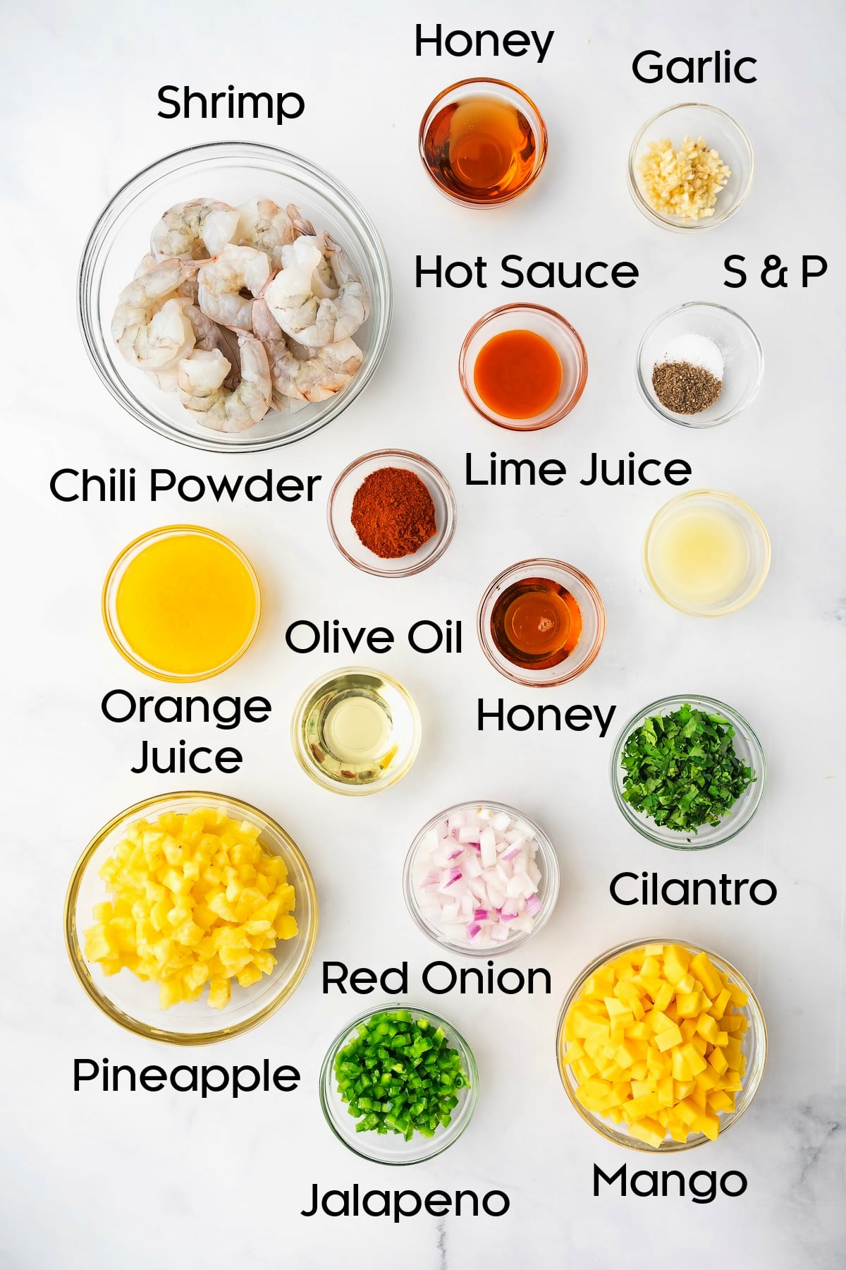 Ingredients for Grilled Shrimp Skewers with Pineapple Mango Salsa in glass bowls.