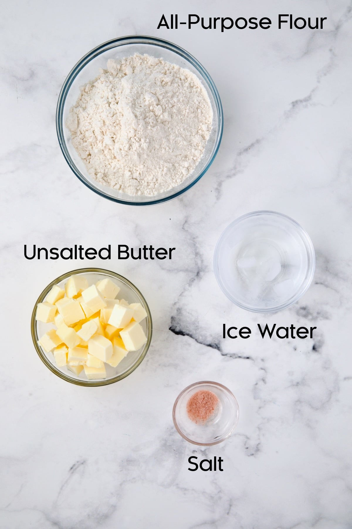 Ingredients for pastry dough in glass bowls.
