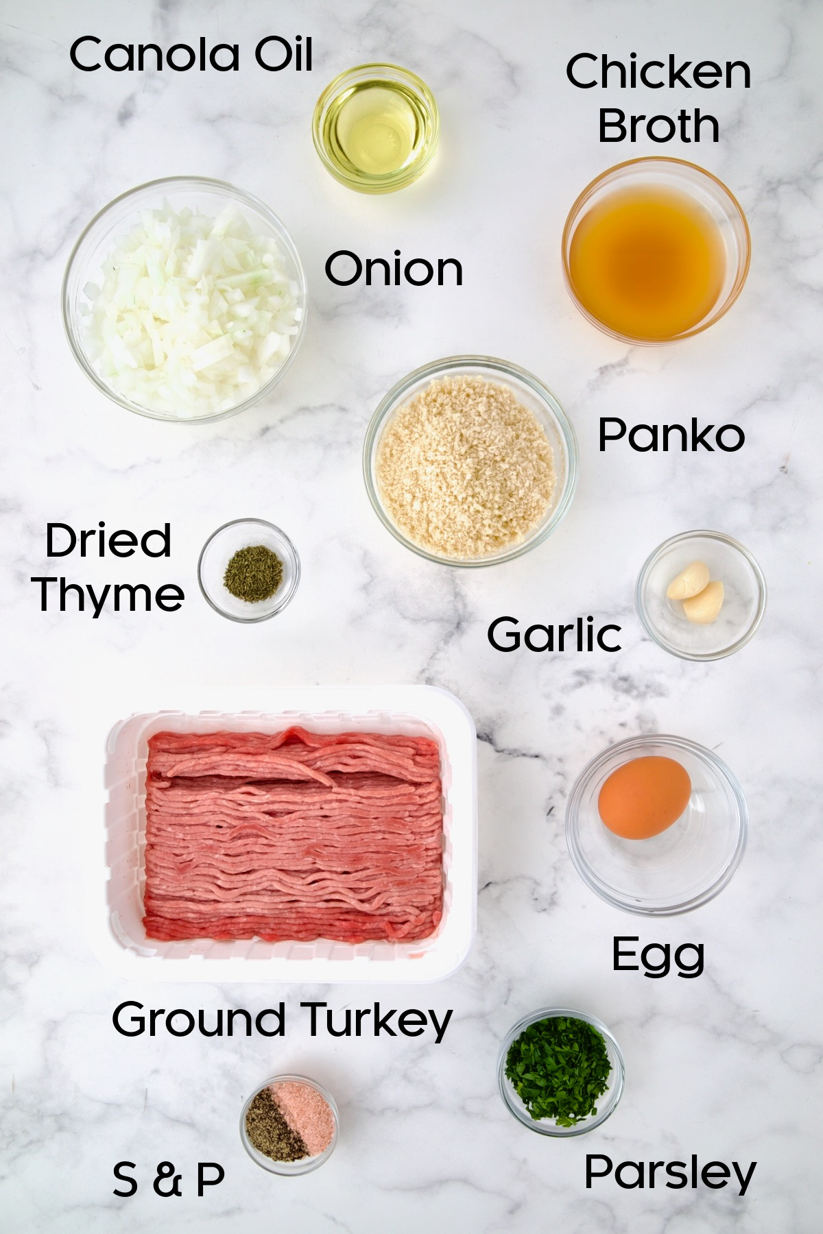 Ingredients for turkey meatballs in glass bowls.