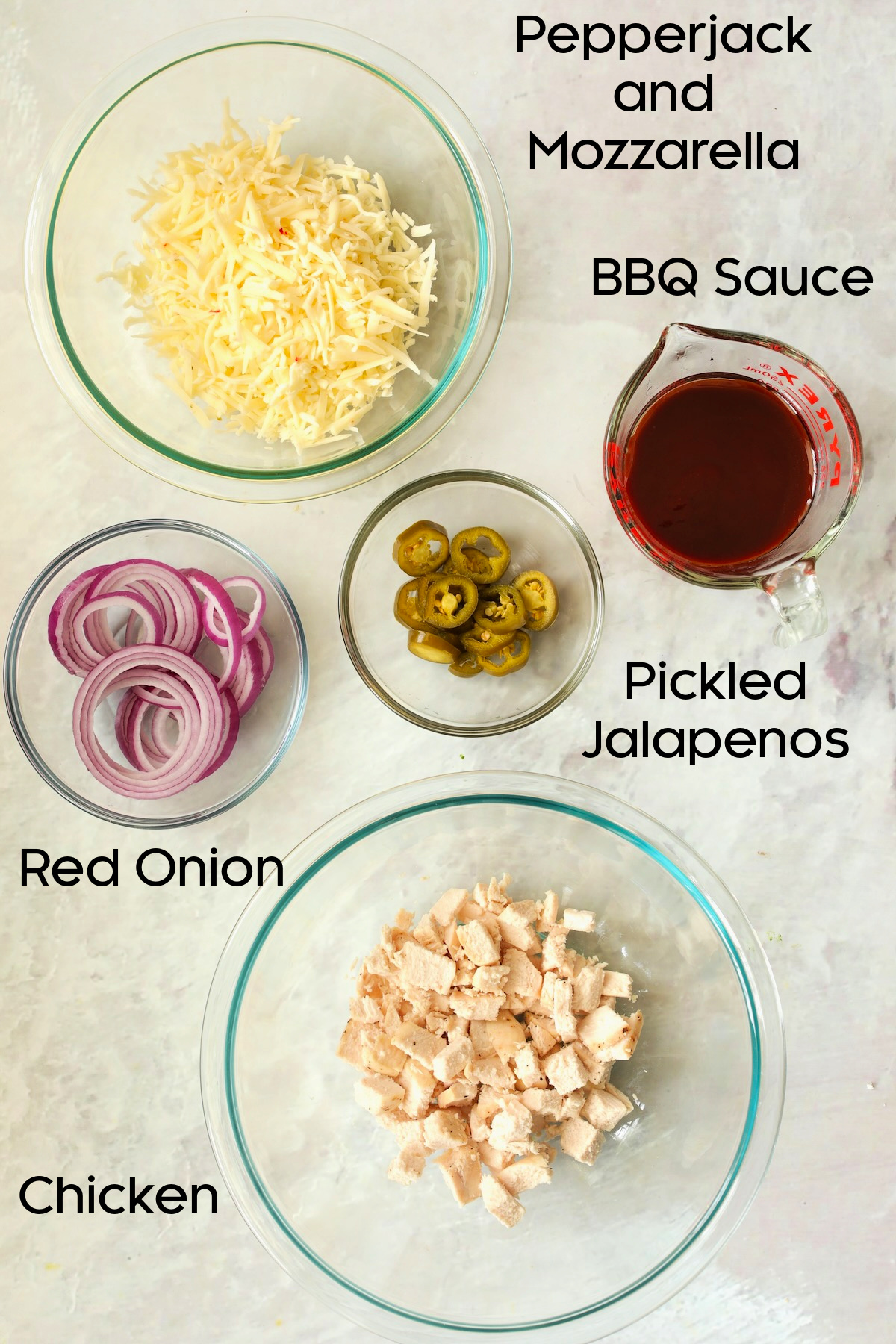 Ingredients for Cast Iron Skillet Pizza in glass bowls.