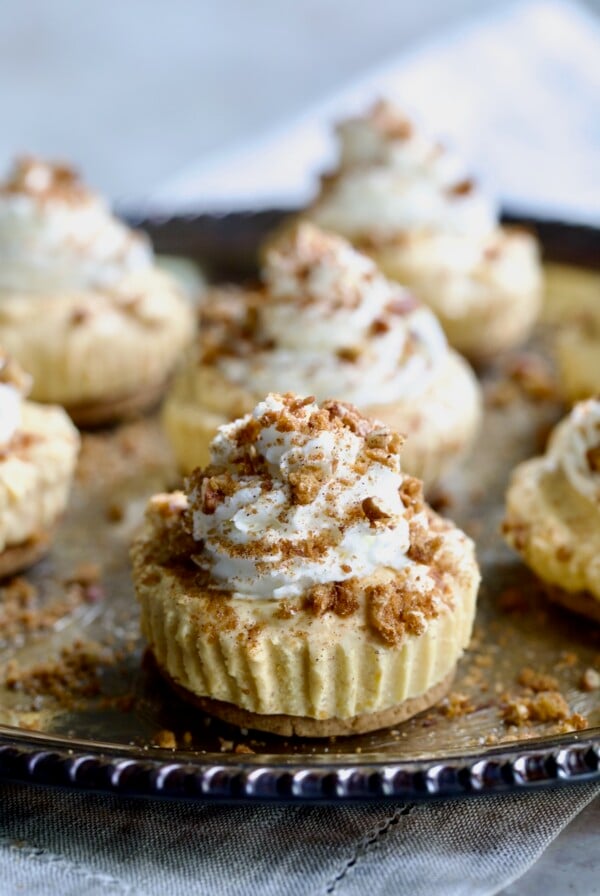 Easy Mini No-Bake Pumpkin Cheesecakes on silver tray.