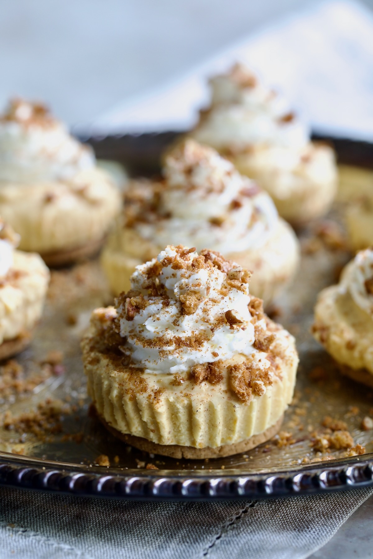 Easy Mini No-Bake Pumpkin Cheesecakes on silver tray.