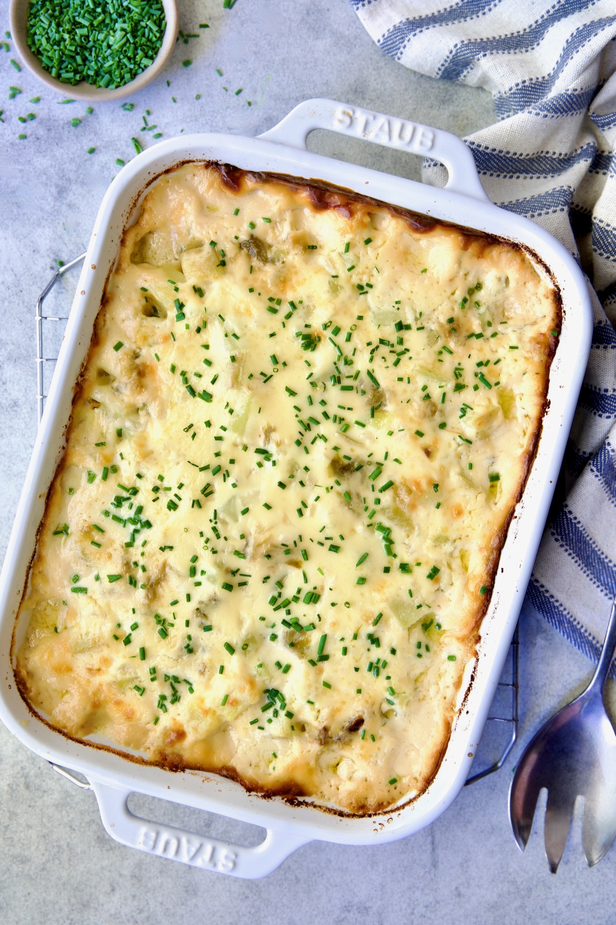 Hatch Green Chile au Gratin Potatoes in white rectangular baking dish.