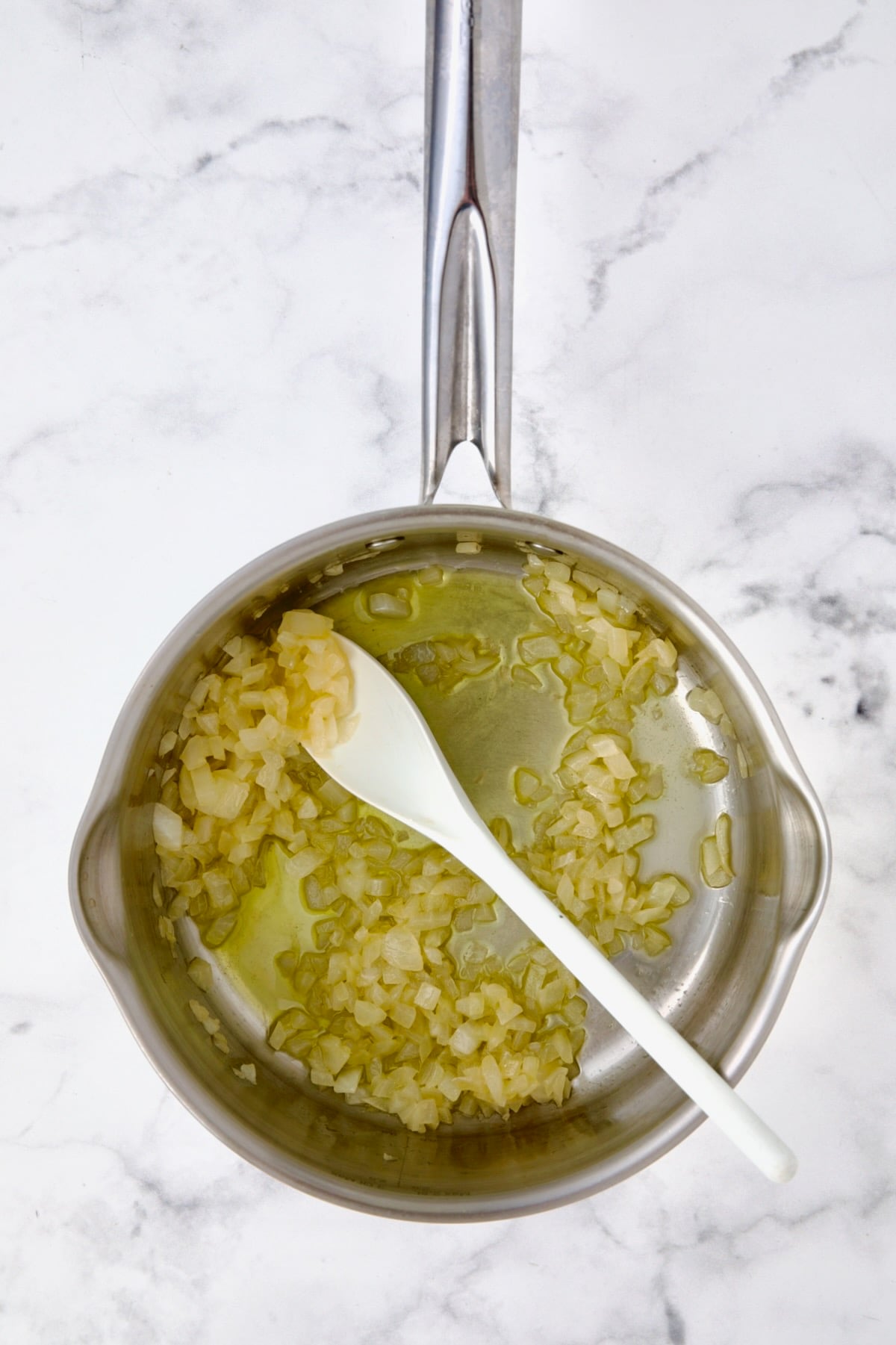 Cooked onions in butter and oil in stainless steel saucepan.
