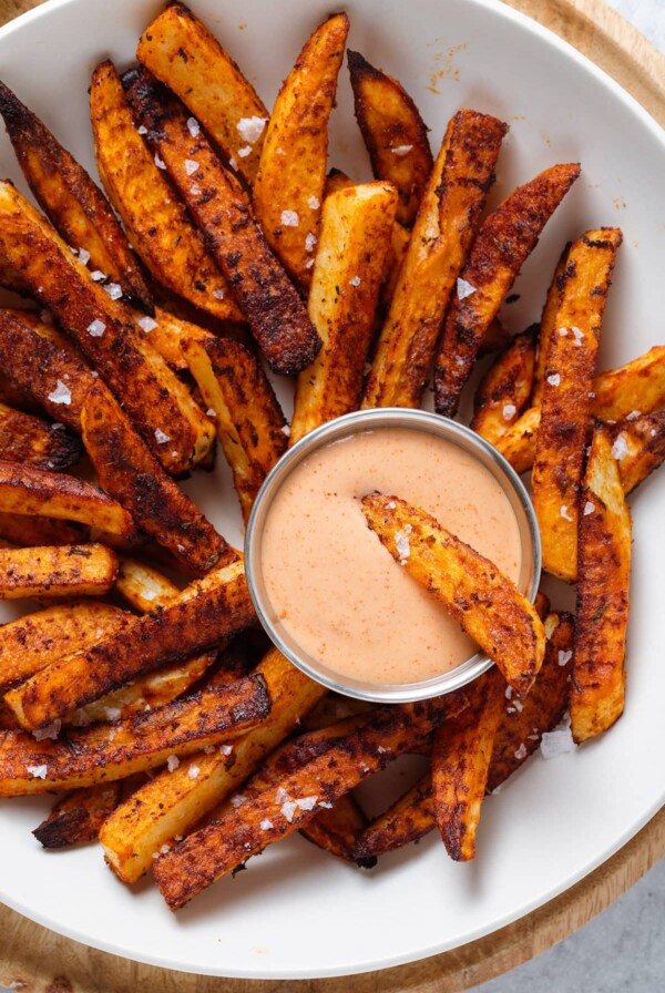 Cajun Fries with House Sauce on white platter.