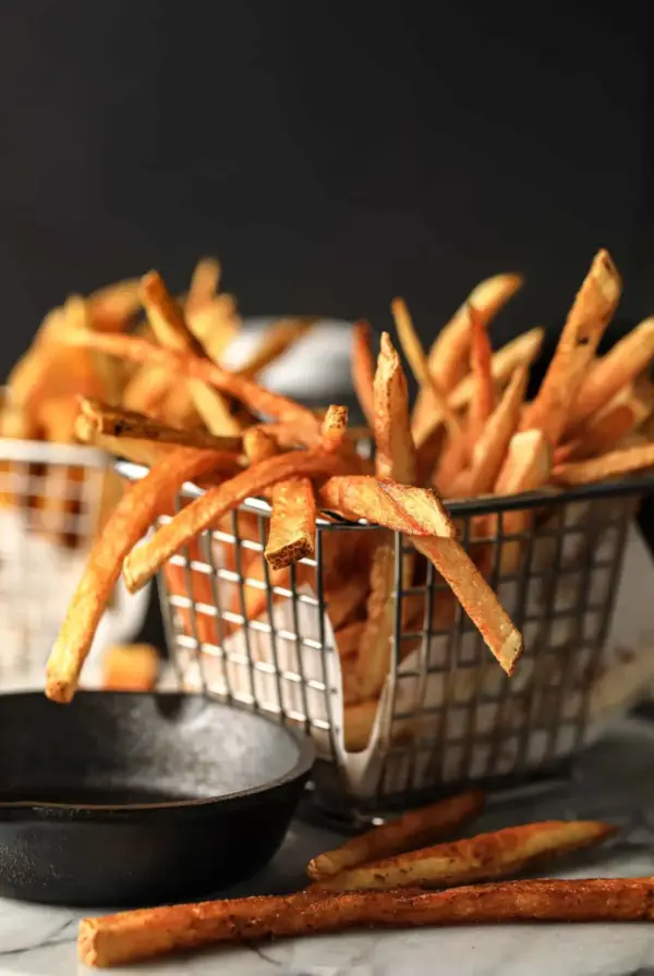 French fries in wire basket.