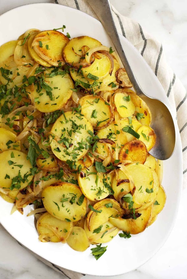 Lyonnaise Potatoes on oval white platter.