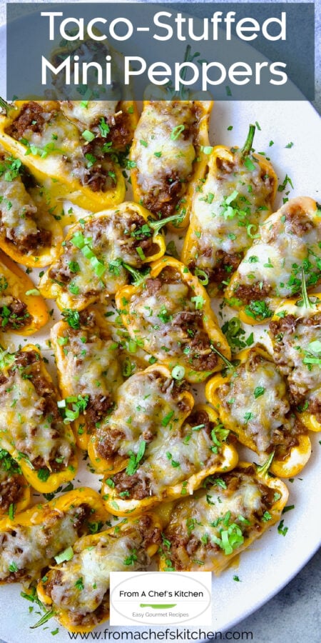 Pinterest graphic for Taco-Stuffed Mini Peppers showing them on a white oval platter.