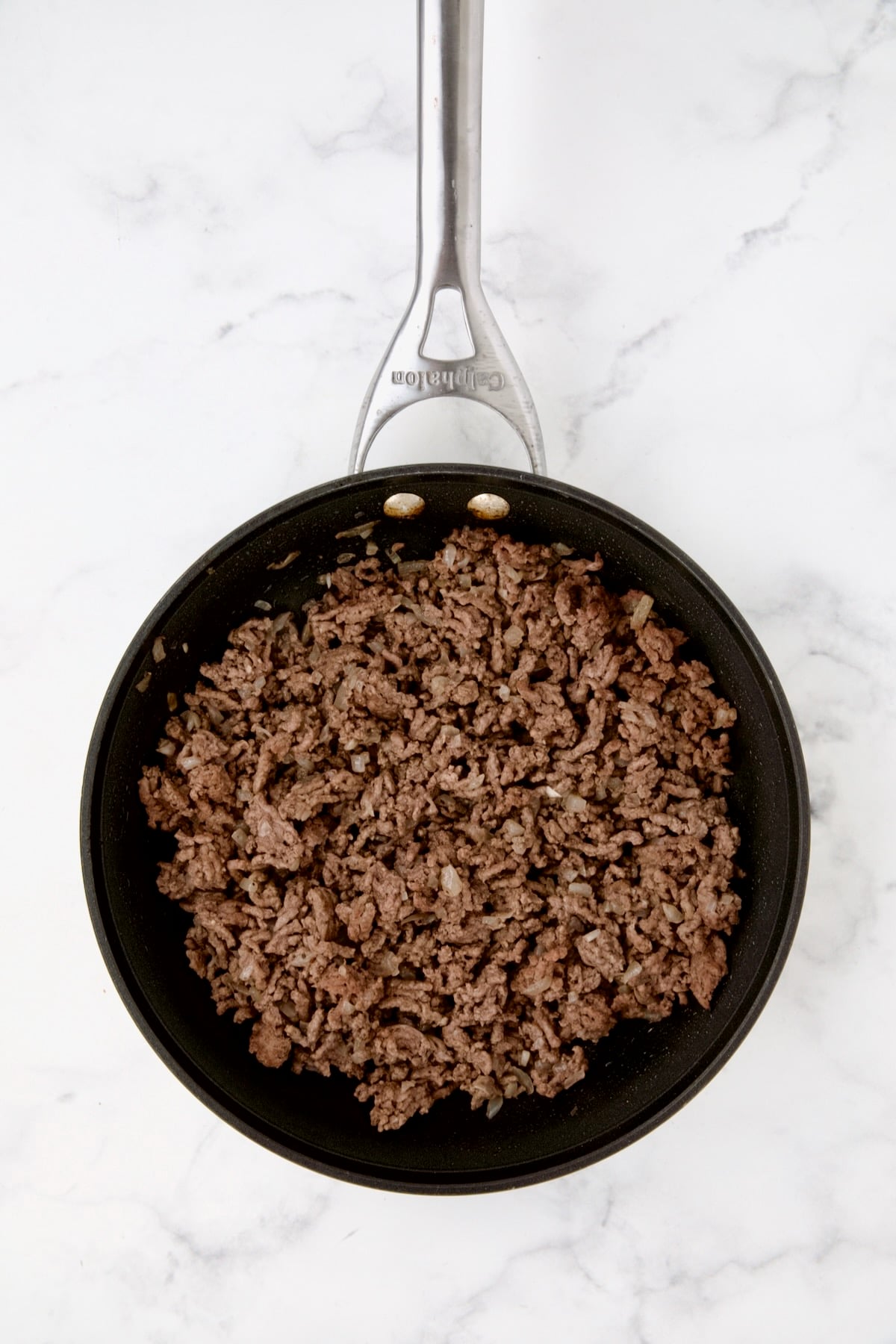 Cooked ground beef in nonstick skillet.