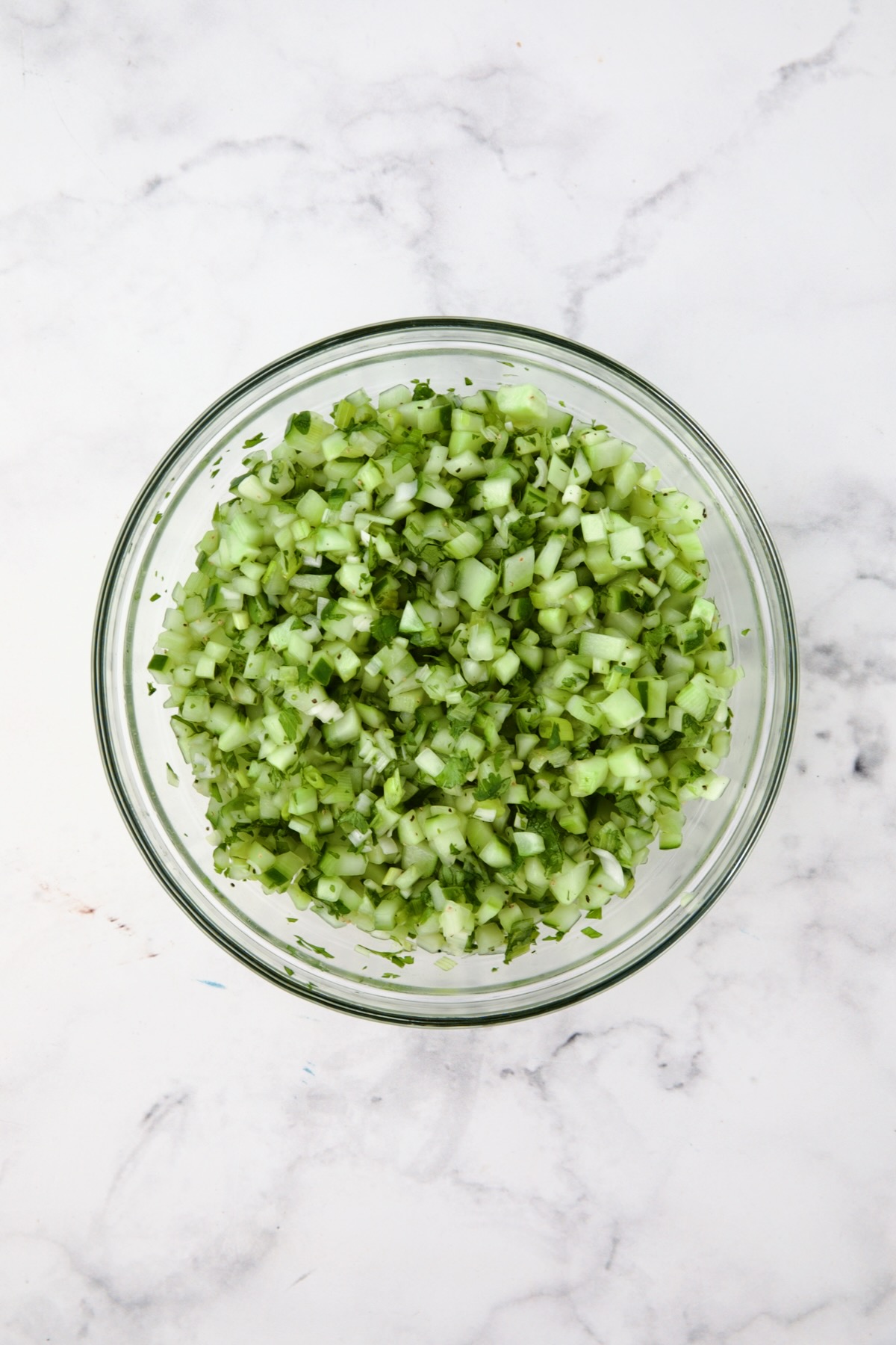 Cucumber relish in glass bowl.