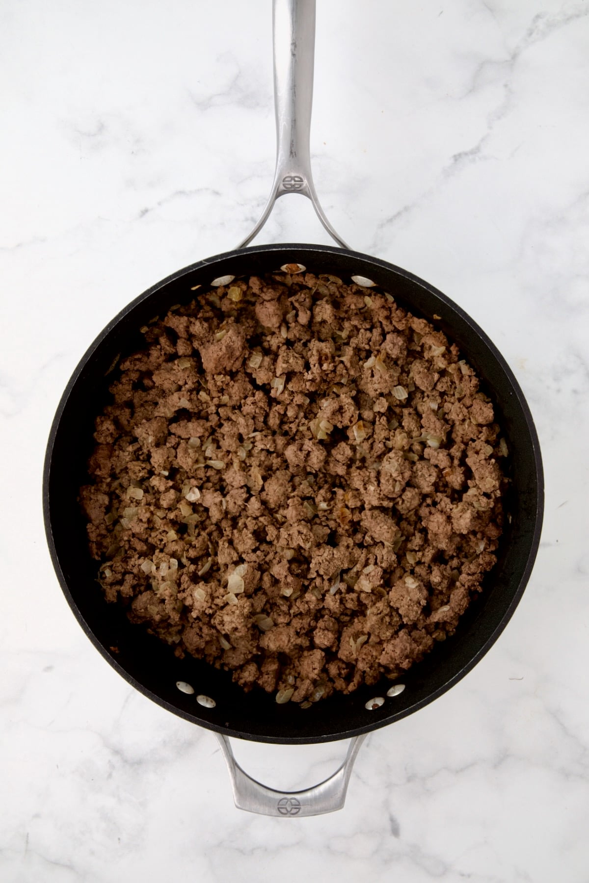 Cooked ground beef in nonstick skillet.