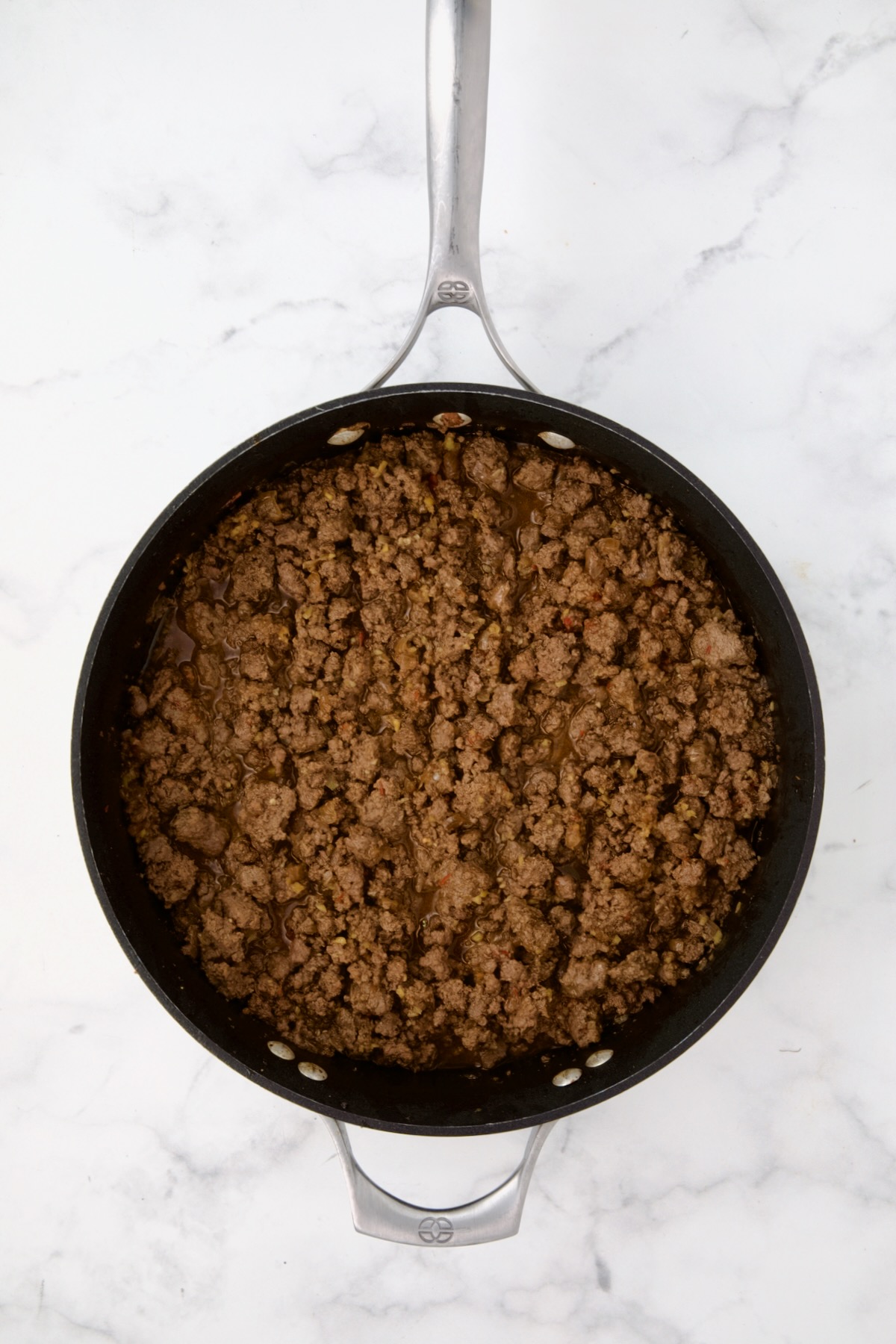 Cooked ground beef mixture in nonstick skillet.