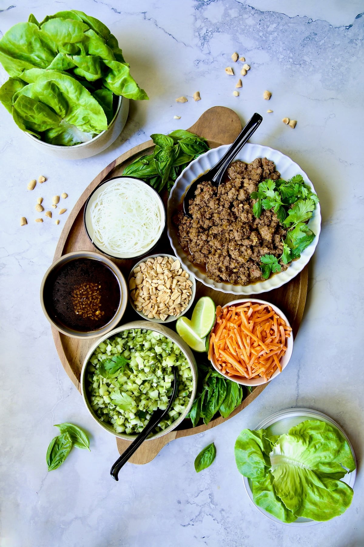 All the fixings for Vietnamese Beef Lettuce Wraps on oval wood platter.