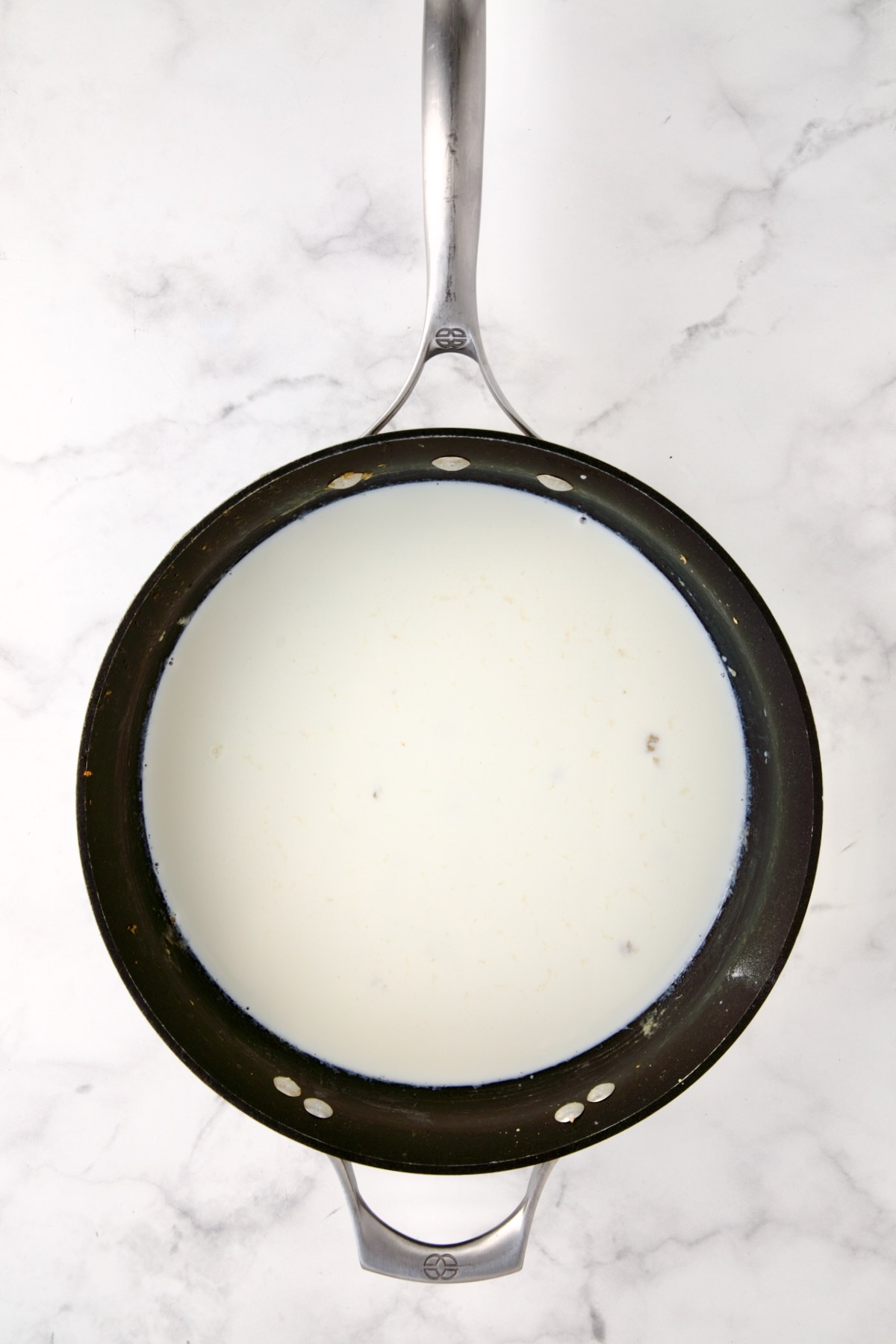 Half-and-half added to nonstick skillet.