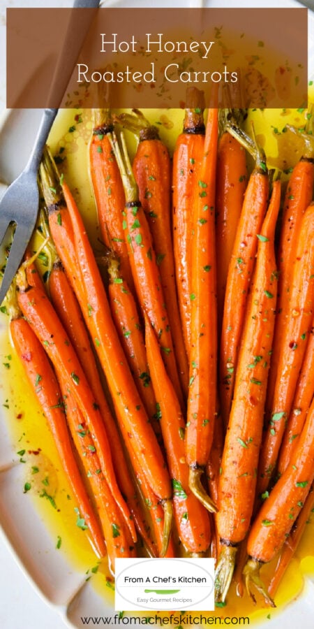 Pinterest graphic for Hot Honey Roasted Carrots on white platter with serving fork.