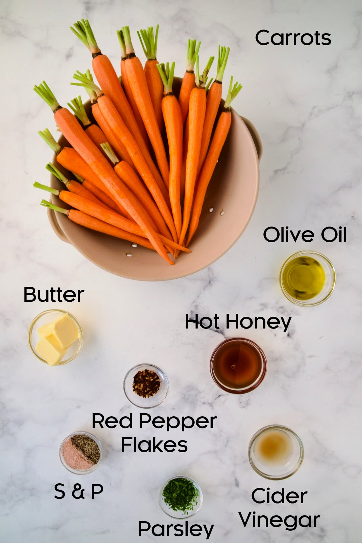 Ingredients for Hot Honey Roasted Carrots in glass bowls.