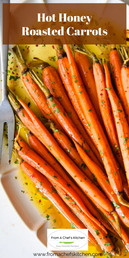 Pinterest graphic for Hot Honey Roasted Carrots on white platter with serving fork.