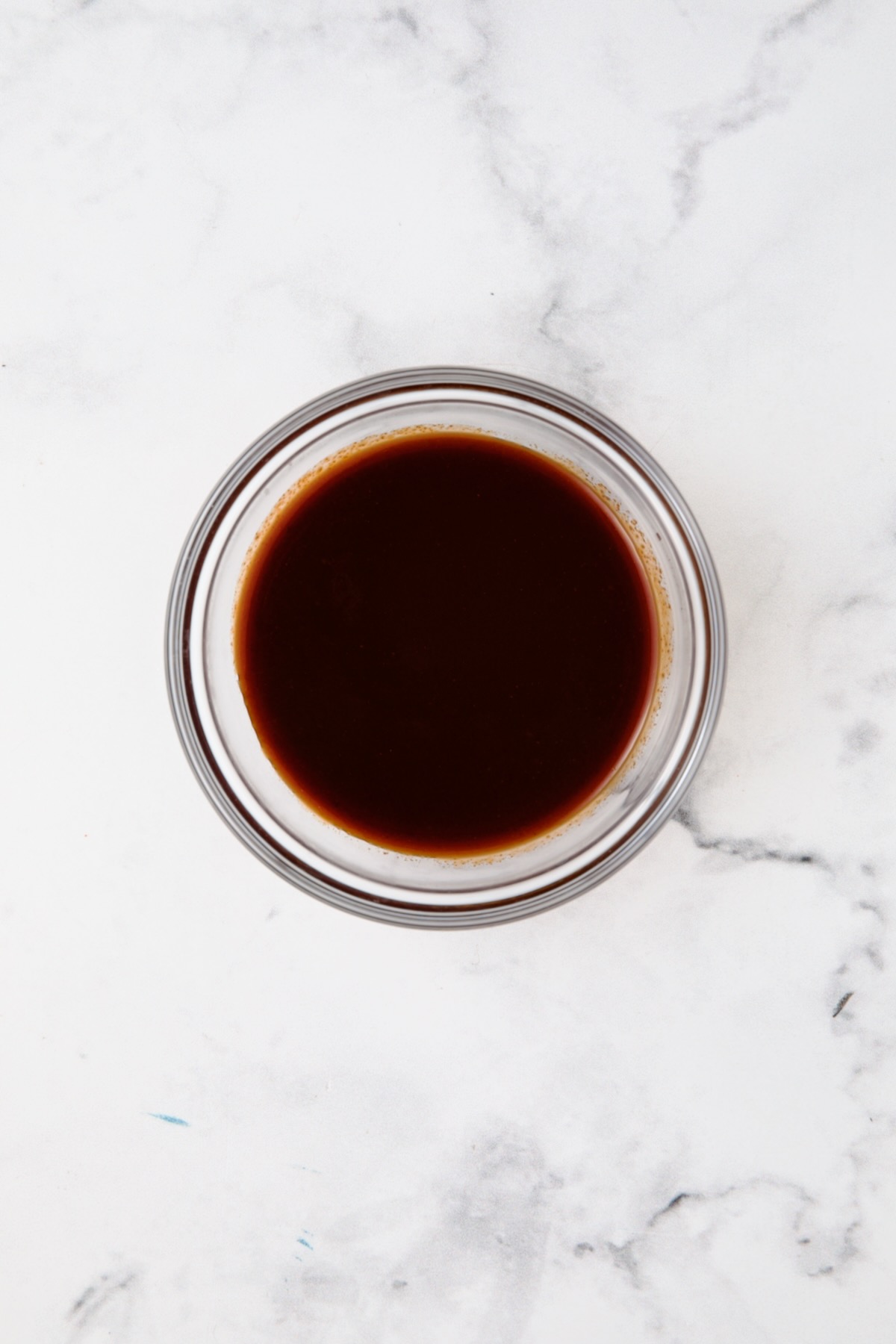 Maple, bacon and gochujang glaze in glass bowl.