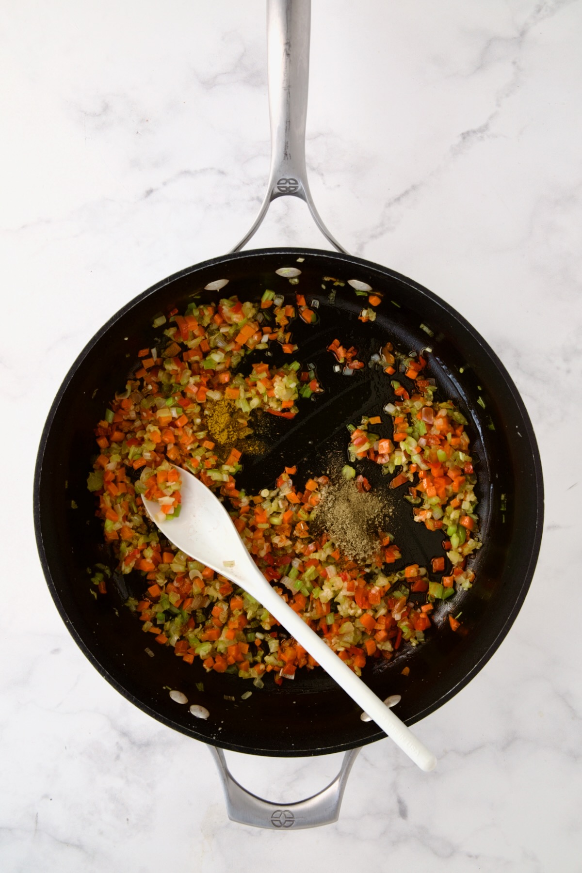 Cooked celery, carrots, red bell pepper and scallion in nonstick skillet with poultry seasoning and curry powder added.