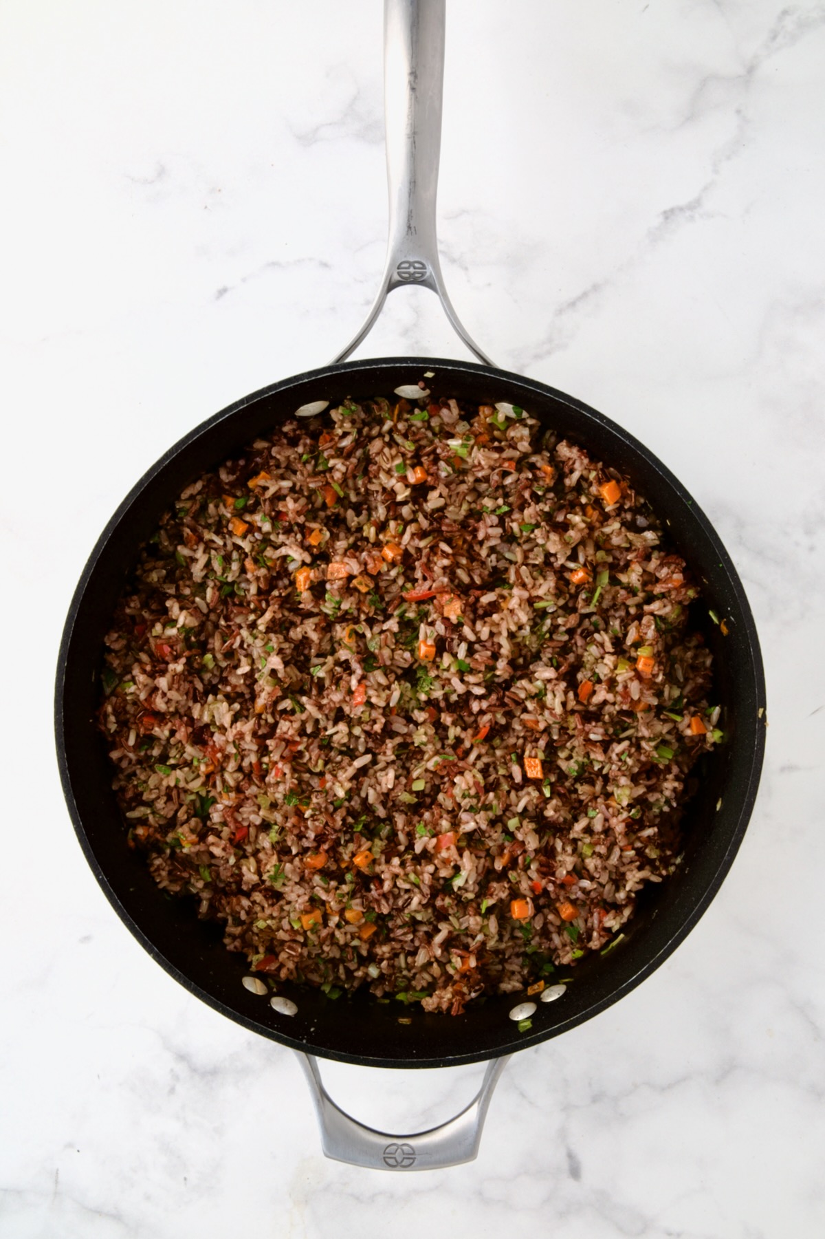 Cooked wild rice pilaf in nonstick skillet.