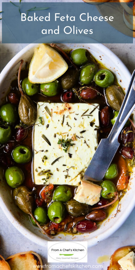 Pinterest graphic for Baked Feta Cheese and Olives showing it in a white oval baking dish.