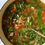 Black-Eyed Pea Soup in white Dutch oven with soup ladle.