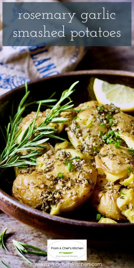 Pinterest graphic for Rosemary Garlic Smashed Potatoes showing them in a brown earthenware bowl garnished with fresh rosemary sprigs.