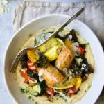 Chicken Sausage Sheet Pan and Polenta in white bowl with fork.
