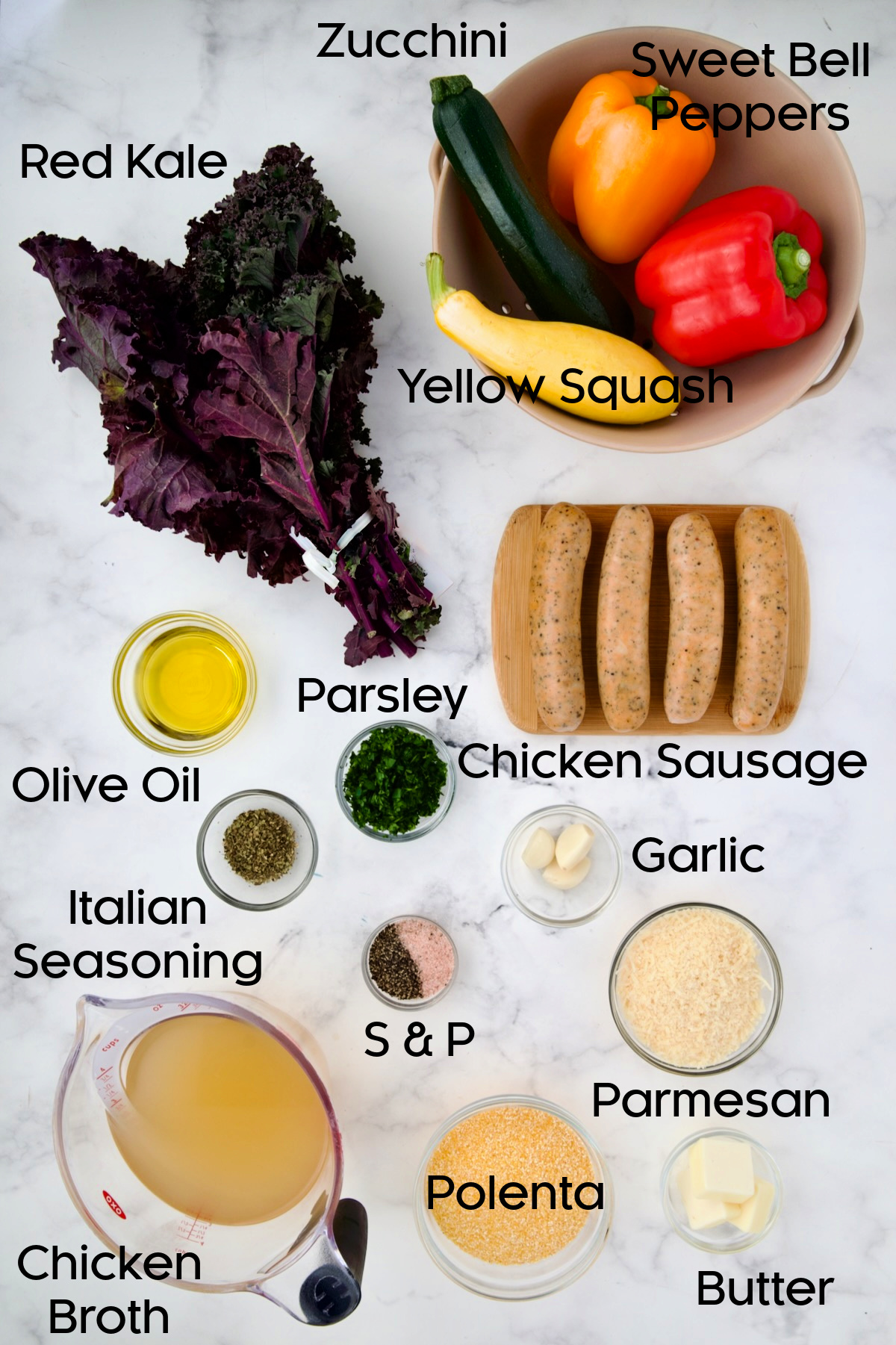 Ingredients for Chicken Sausage Sheet Pan and Polenta on white marble surface.