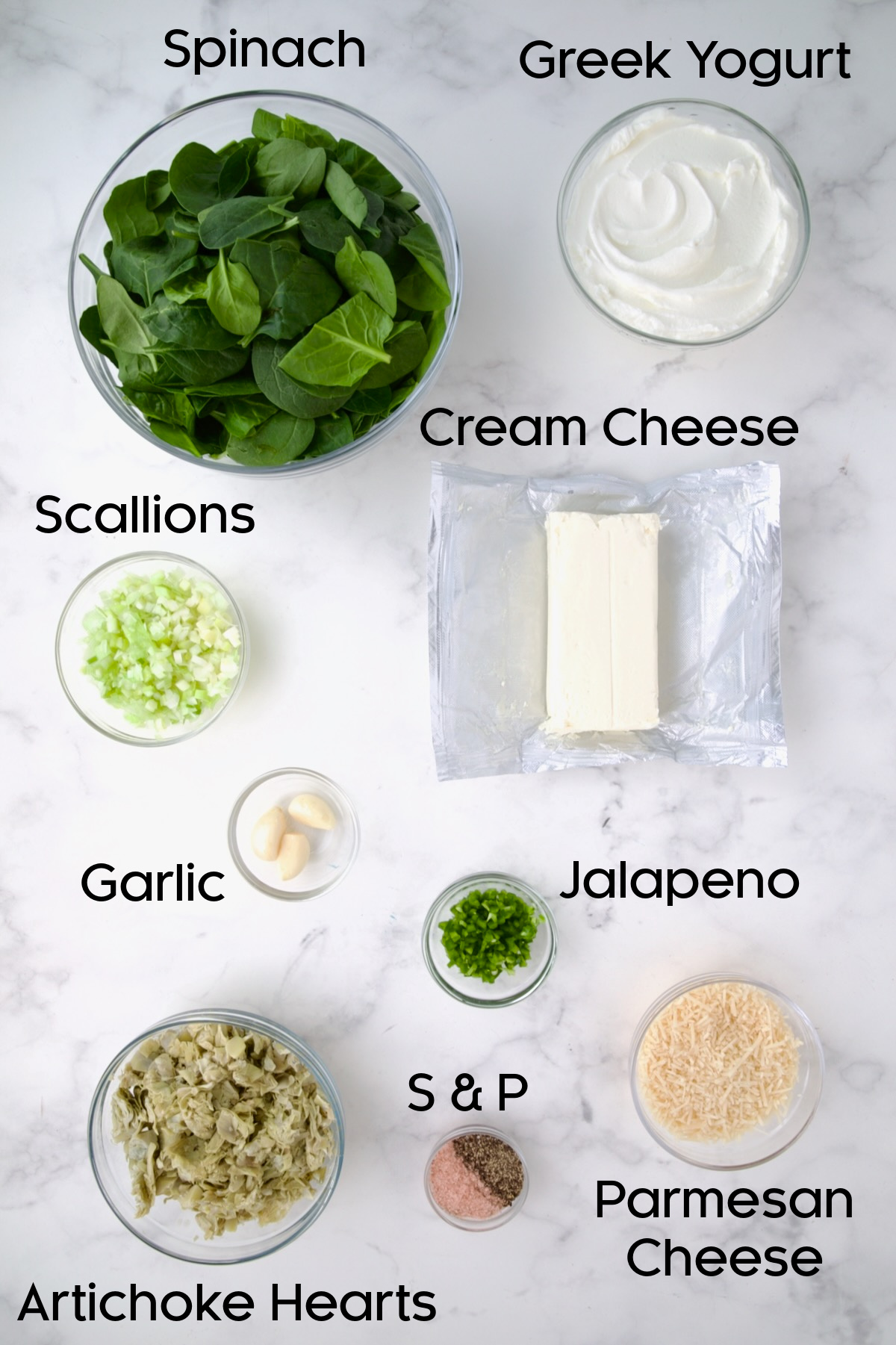 Ingredients for Spinach Artichoke Dip in glass bowls.