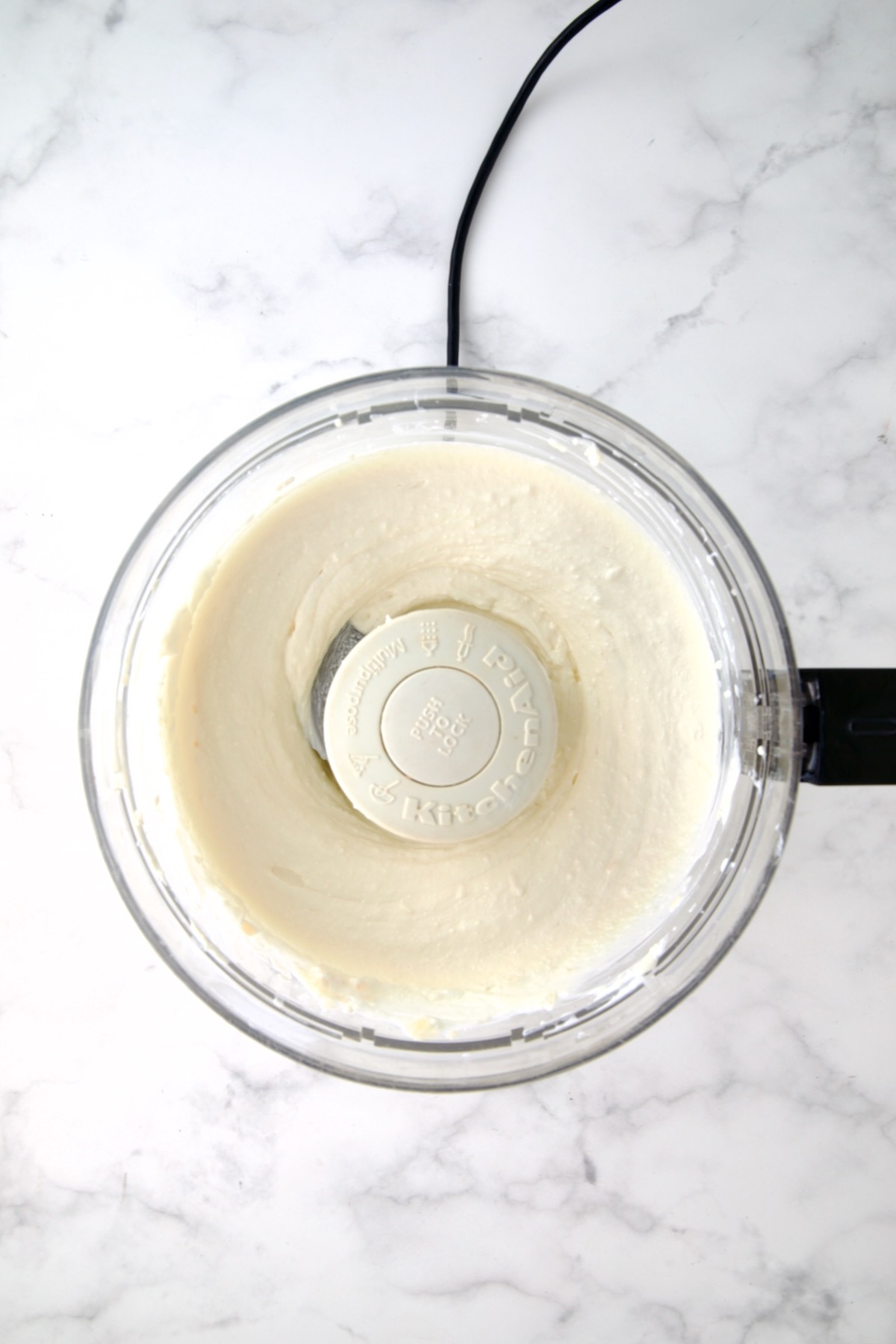 Yogurt and cream cheese in food processor.